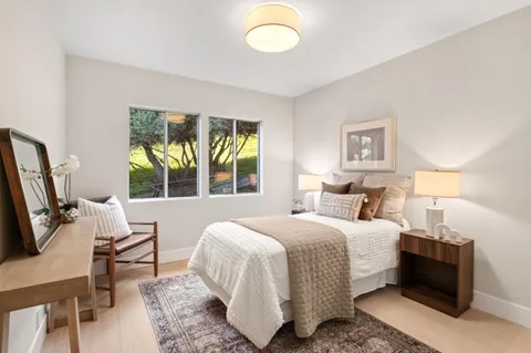 a bedroom with a bed and a night stand