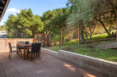 a view of a house with backyard and sitting area