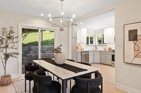 a view of a dining room with furniture window and outside view