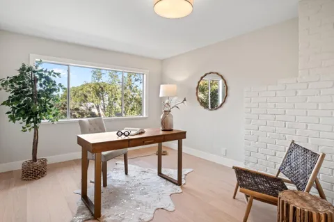 a view of a room with a table and chairs
