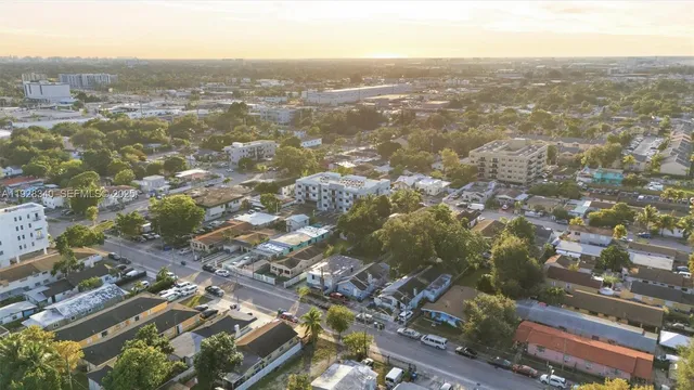 an aerial view of residential houses with city view