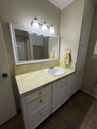 a bathroom with a sink double vanity and a mirror