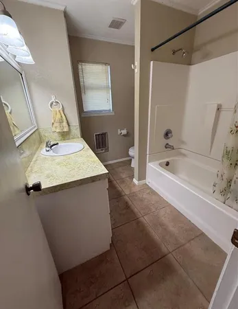 a bathroom with a bathtub sink and mirror