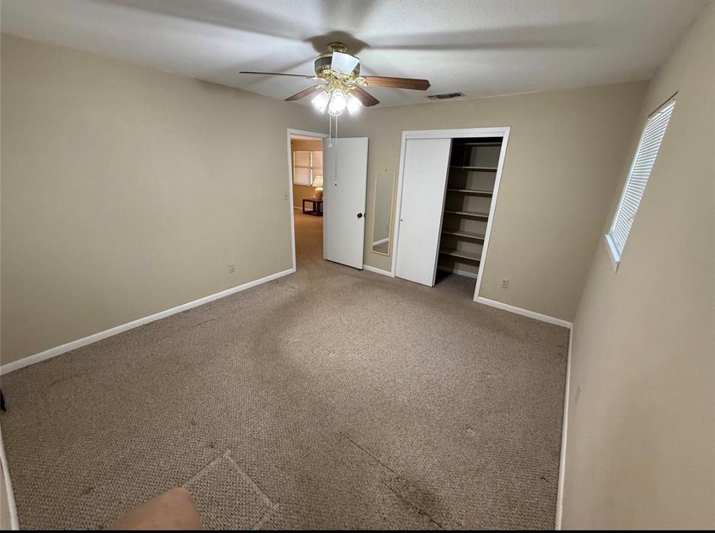 105 West Elm Gustine, TX 76455 - Photo 16 of 21 an empty room with closet and a ceiling fan