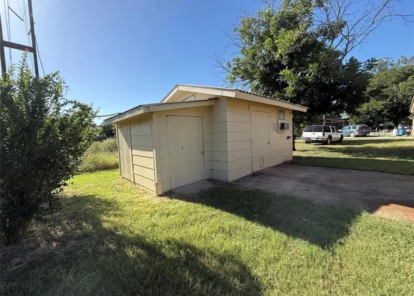 a view of backyard of house with green space