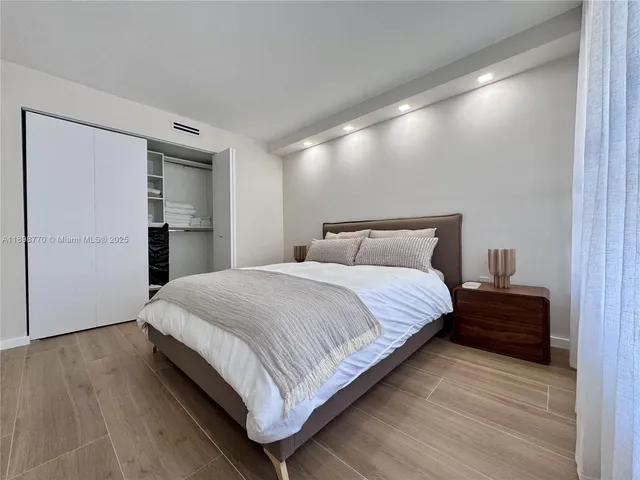 a bedroom with a bed and a walk in closet