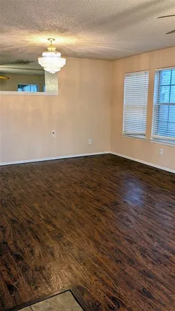 a view of wooden floor and windows in a room