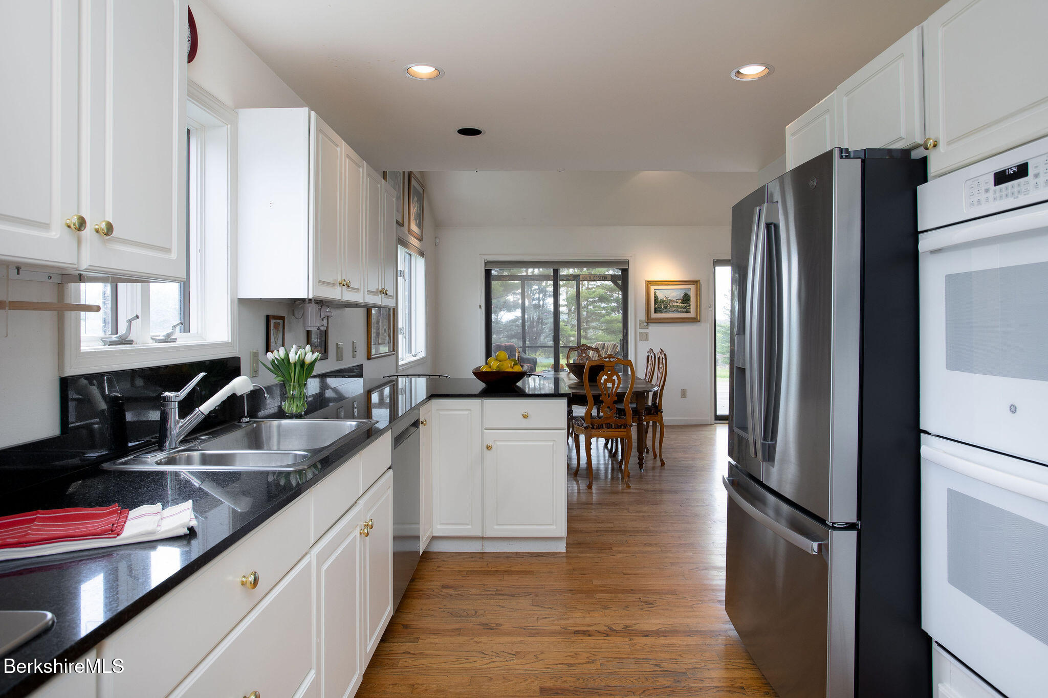 77 Hurlburt Road Great Barrington, MA 01230 - Photo 22 of 48 a kitchen with counter top space a sink appliances and cabinets