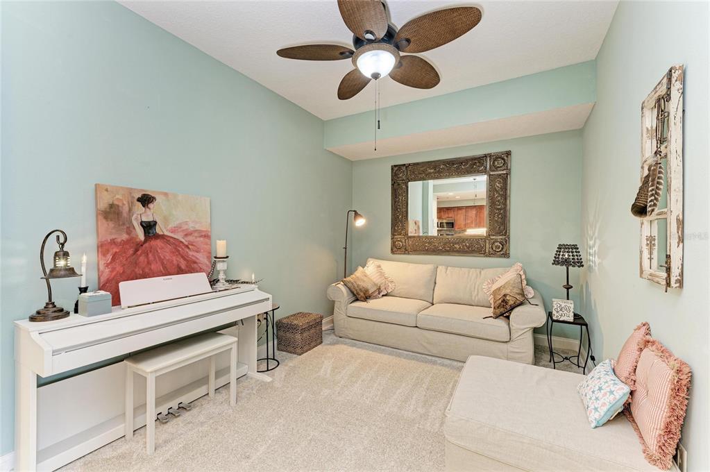 610 Riviera Dunes Way, Unit 406 Palmetto, FL 34221 - Photo 11 of 49 a living room with furniture and a ceiling fan