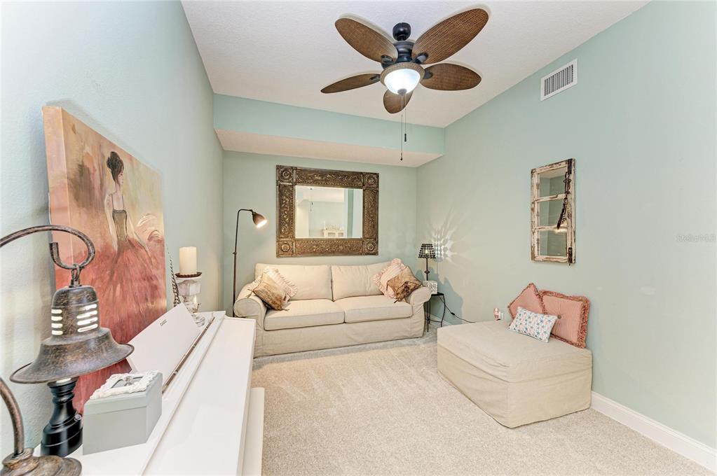 610 Riviera Dunes Way, Unit 406 Palmetto, FL 34221 - Photo 12 of 49 a living room with furniture and a chandelier
