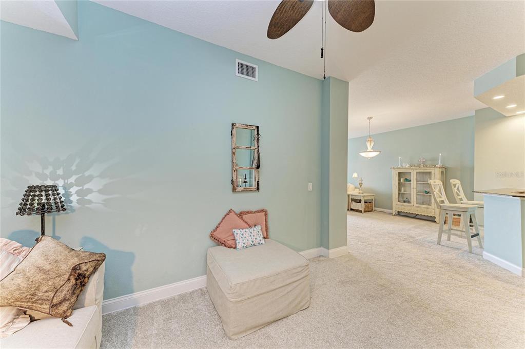 610 Riviera Dunes Way, Unit 406 Palmetto, FL 34221 - Photo 13 of 49 a bedroom with furniture and a chandelier