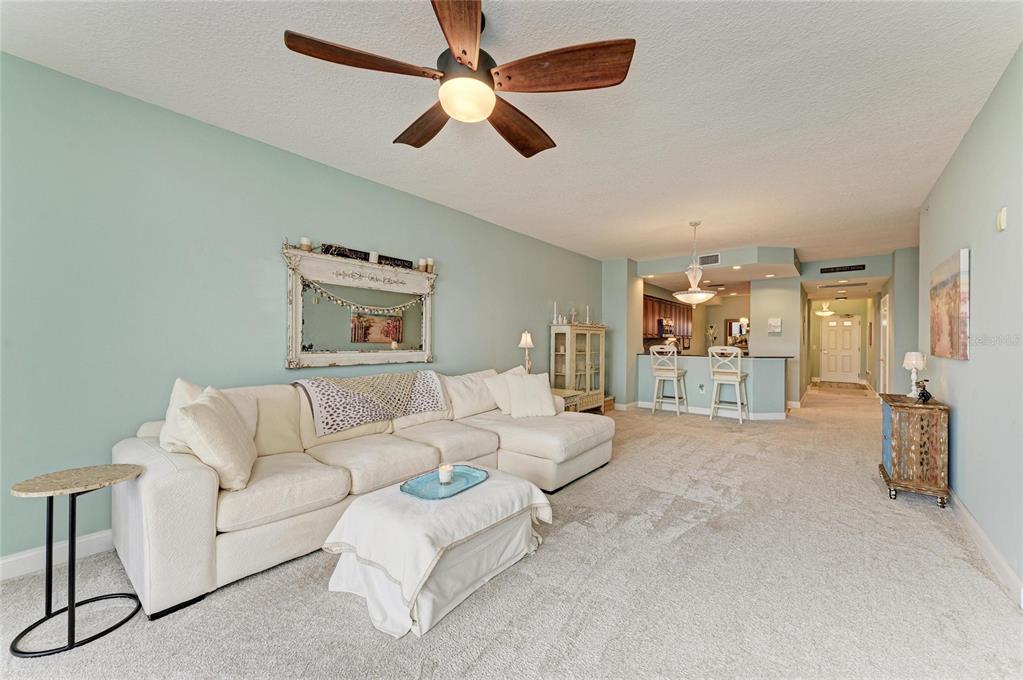 610 Riviera Dunes Way, Unit 406 Palmetto, FL 34221 - Photo 18 of 49 a living room with furniture and a ceiling fan