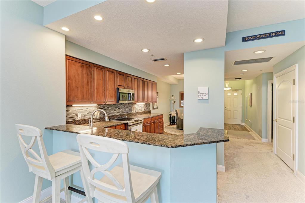 610 Riviera Dunes Way, Unit 406 Palmetto, FL 34221 - Photo 20 of 49 a kitchen with center island and stainless steel appliances
