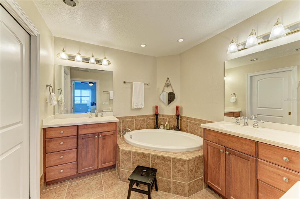 610 Riviera Dunes Way, Unit 406 Palmetto, FL 34221 - Photo 31 of 49 a bathroom with a double vanity sink and a mirror
