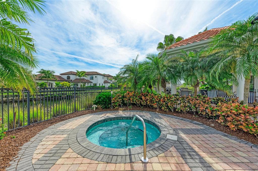 610 Riviera Dunes Way, Unit 406 Palmetto, FL 34221 - Photo 40 of 49 a view of a swimming pool with a yard