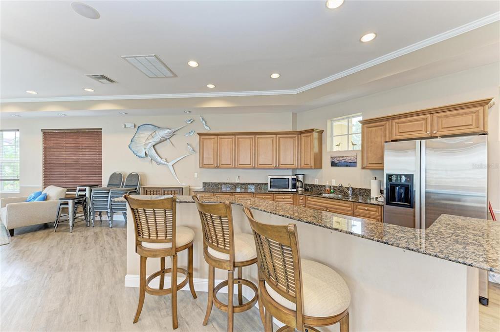 610 Riviera Dunes Way, Unit 406 Palmetto, FL 34221 - Photo 44 of 49 a large kitchen with a table and chairs