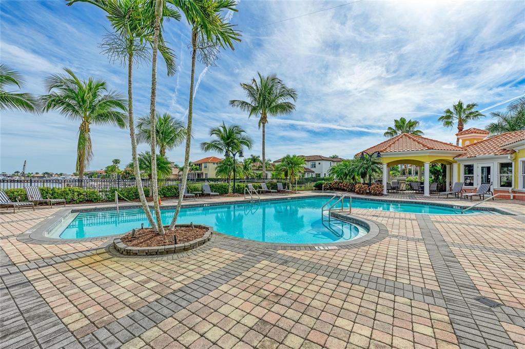 610 Riviera Dunes Way, Unit 406 Palmetto, FL 34221 - Photo 48 of 49 a view of a swimming pool with a table and chairs