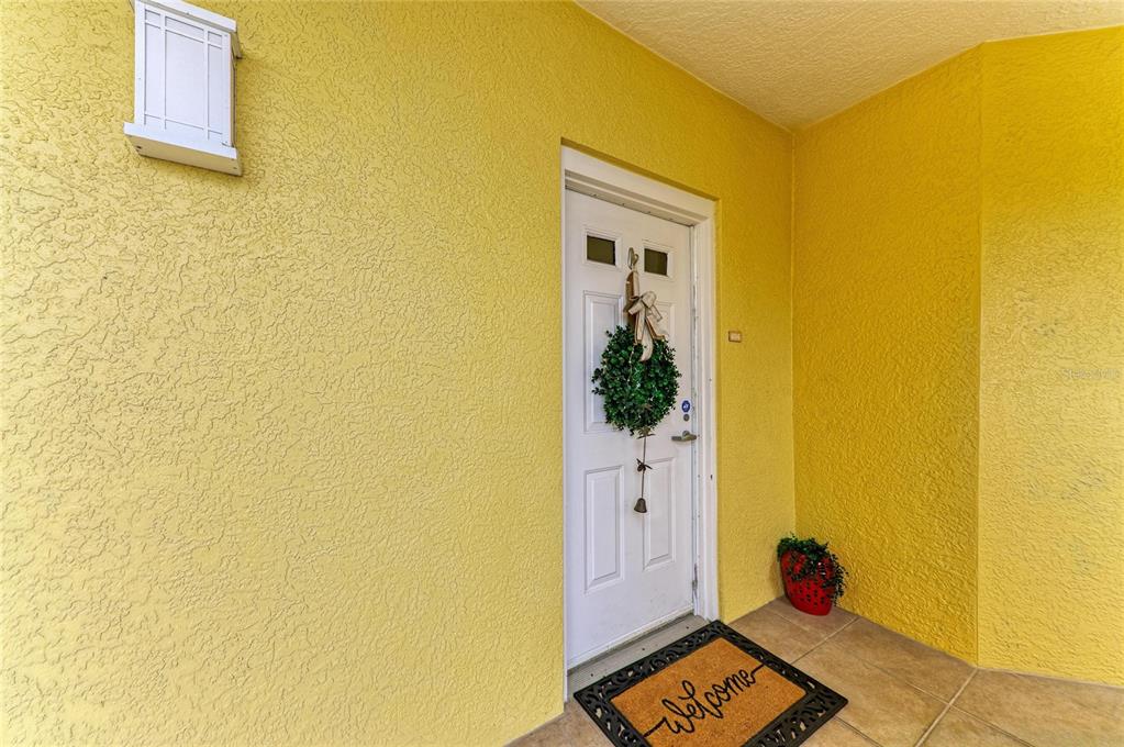 610 Riviera Dunes Way, Unit 406 Palmetto, FL 34221 - Photo 8 of 49 a room with a door and wooden floor