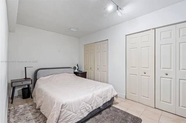 a bedroom with a bed and a mirror