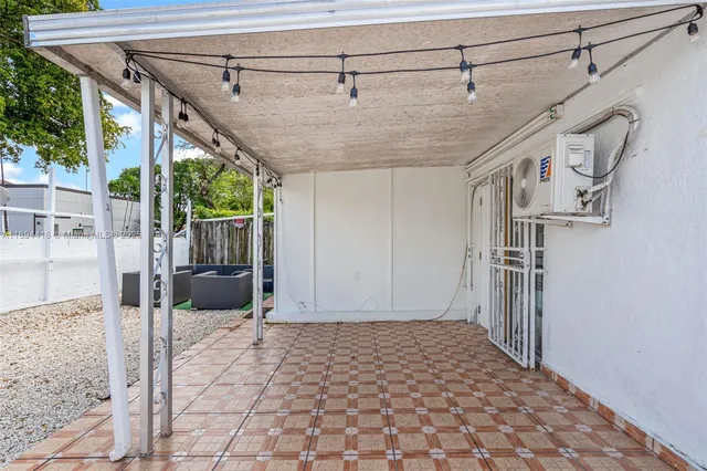 a view of a patio with table and chairs with wooden fence