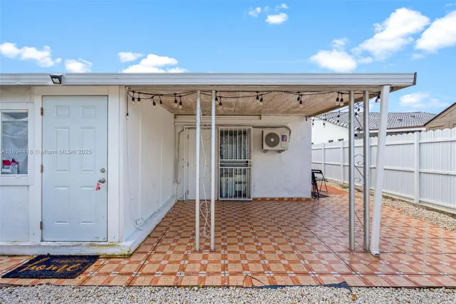 a view of a couches and dinning table in patio