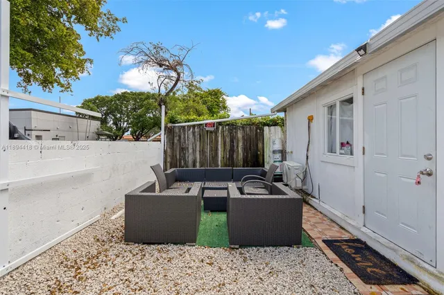 a living room with furniture a chandelier and a floor to ceiling window