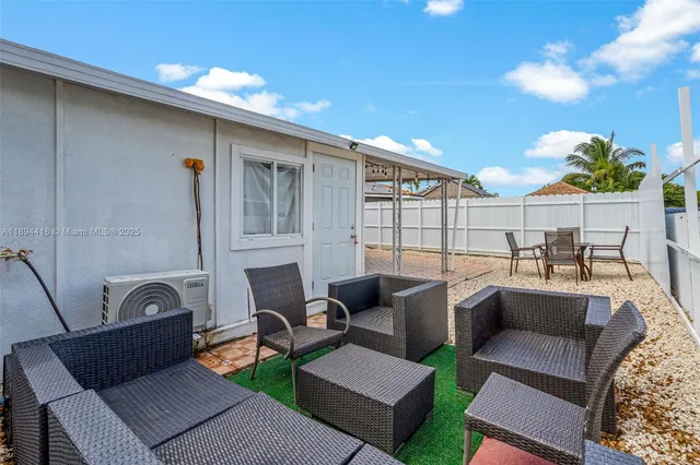 a kitchen with stainless steel appliances white cabinets and wooden floor