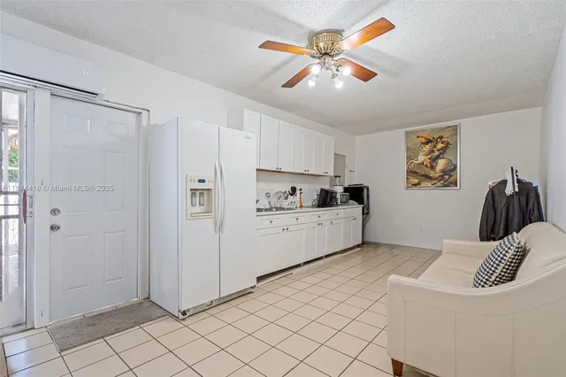 a hallway with white walls and white cabinet