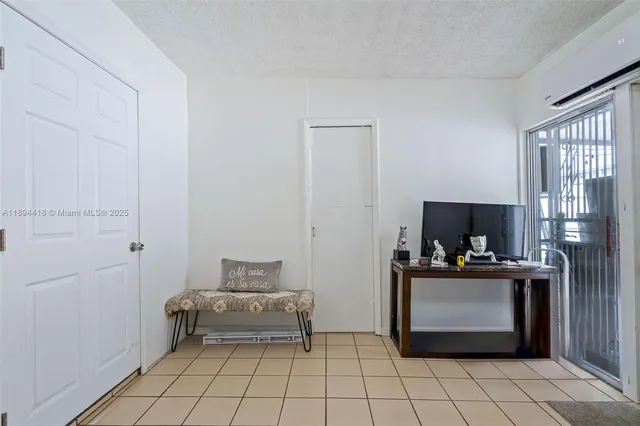 a bedroom with a bed a dresser and a window