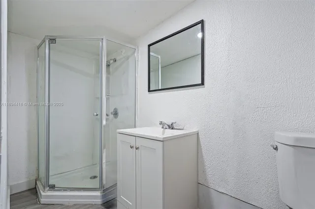 a bathroom with a sink a toilet and mirror