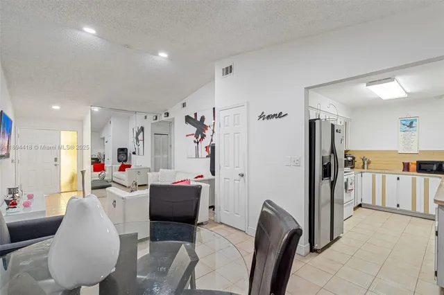 a kitchen with stainless steel appliances granite countertop a refrigerator and a stove