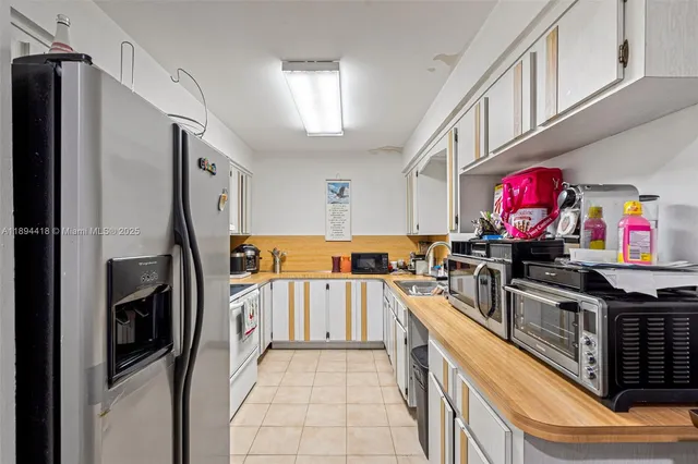 a kitchen with stainless steel appliances a stove a sink a stove and a refrigerator