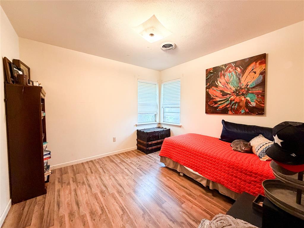 1706 North Ave H Haskell, TX 79521 - Photo 18 of 25 a bedroom with furniture and wooden floor