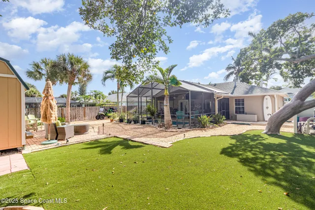 a view of a house with backyard and sitting area