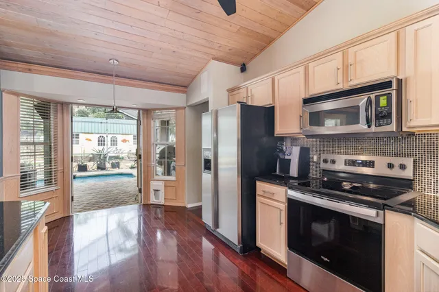 a kitchen with stainless steel appliances granite countertop a stove microwave and refrigerator