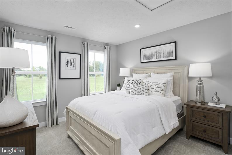 3422 Fox Pointe Lane York, PA 17404 - Photo 23 of 27 a bedroom with a bed and a lamp on table