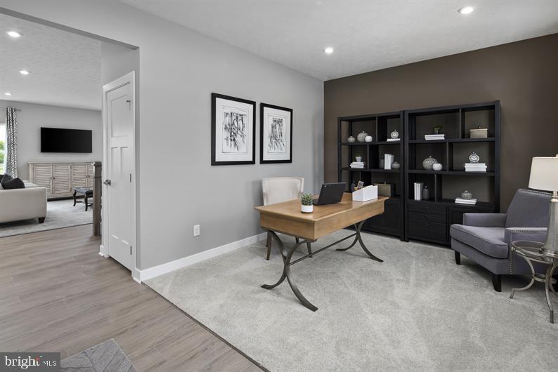 3422 Fox Pointe Lane York, PA 17404 - Photo 3 of 27 a living room with furniture a rug and a flat screen tv