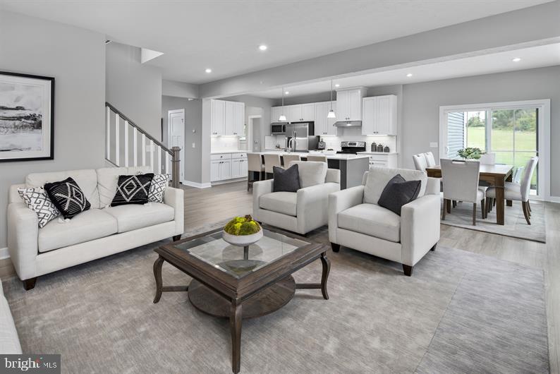 3422 Fox Pointe Lane York, PA 17404 - Photo 7 of 27 a living room with furniture and a dining table with kitchen view