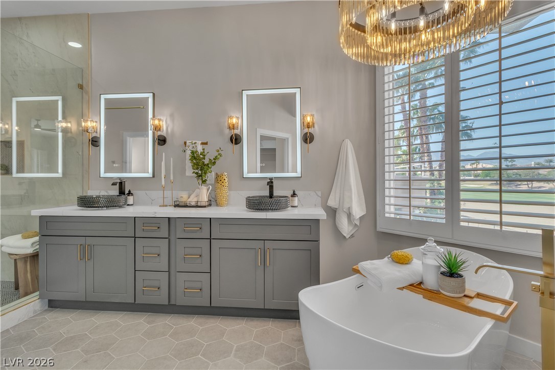 8848 Rainbow Ridge Drive Las Vegas, NV 89117 - Photo 30 of 43 Luxurious primary bath features dual vanities, a separate soaking tub, and an invigorating walk-in shower.