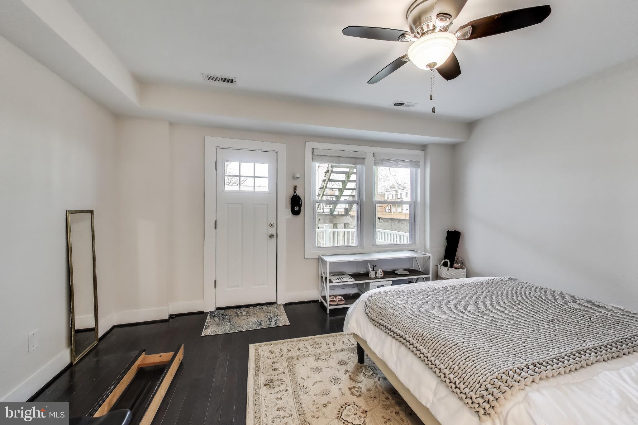 426 18th Street Northeast, Unit 2 Washington, DC 20002 - Photo 7 of 20 a bedroom with a large bed and a chandelier