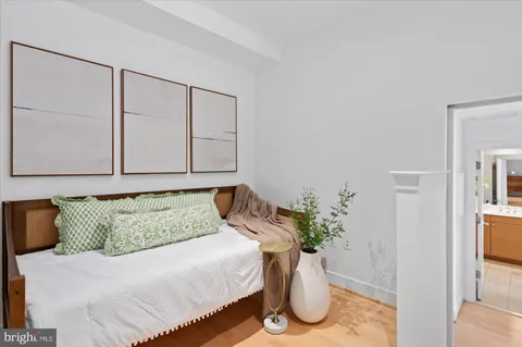 a bedroom with a bed and a potted plant