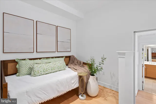 a bedroom with a bed and a potted plant