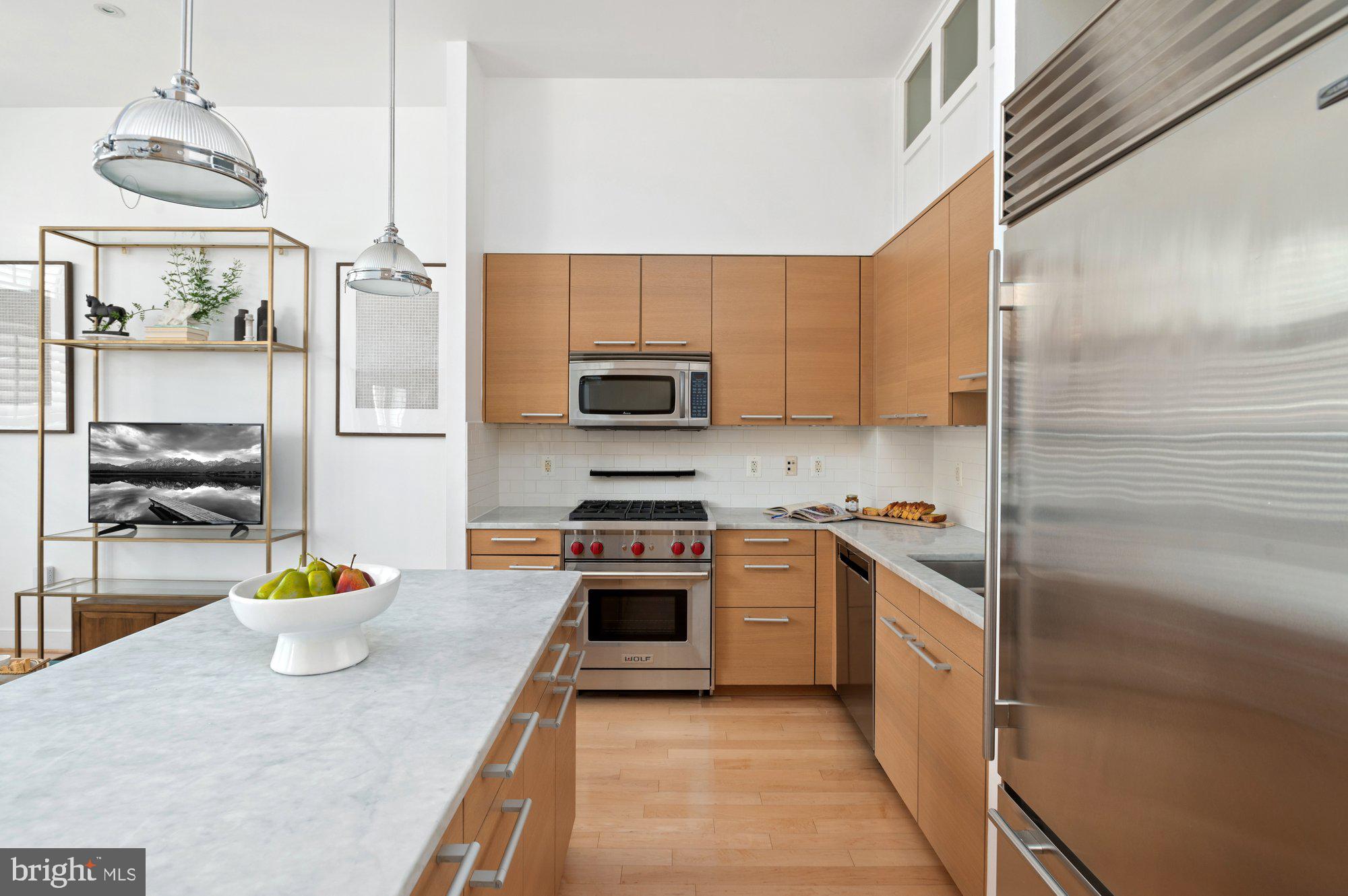 2425 L Street Northwest, Unit 620 Washington, DC 20037 - Photo 3 of 35 a kitchen with stainless steel appliances granite countertop a sink a stove and a refrigerator