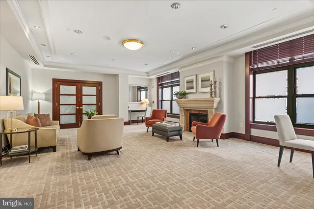 a living room with furniture fireplace and a large window