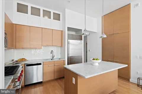 a kitchen with a sink a stove and cabinets