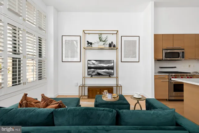 a living room with furniture and a kitchen area