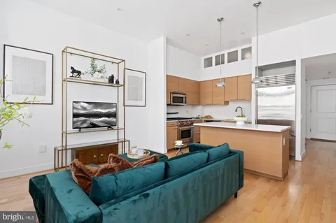 a living room with furniture and a kitchen view
