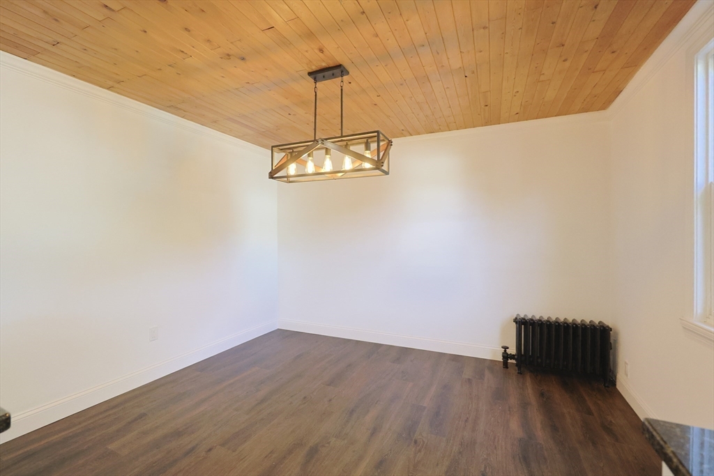 21 Irving Street Bellingham, MA 02019 - Photo 14 of 39 a view of a room with wooden floor and chandelier
