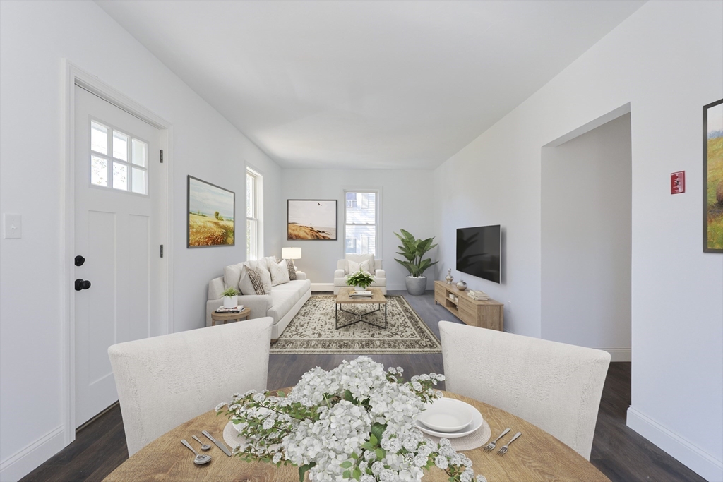 21 Irving Street Bellingham, MA 02019 - Photo 16 of 39 a living room with furniture a flat screen tv and a large window