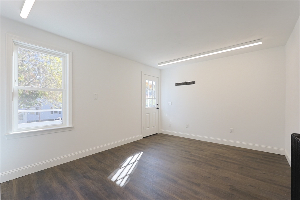 21 Irving Street Bellingham, MA 02019 - Photo 21 of 39 a view of an empty room with wooden floor and a window